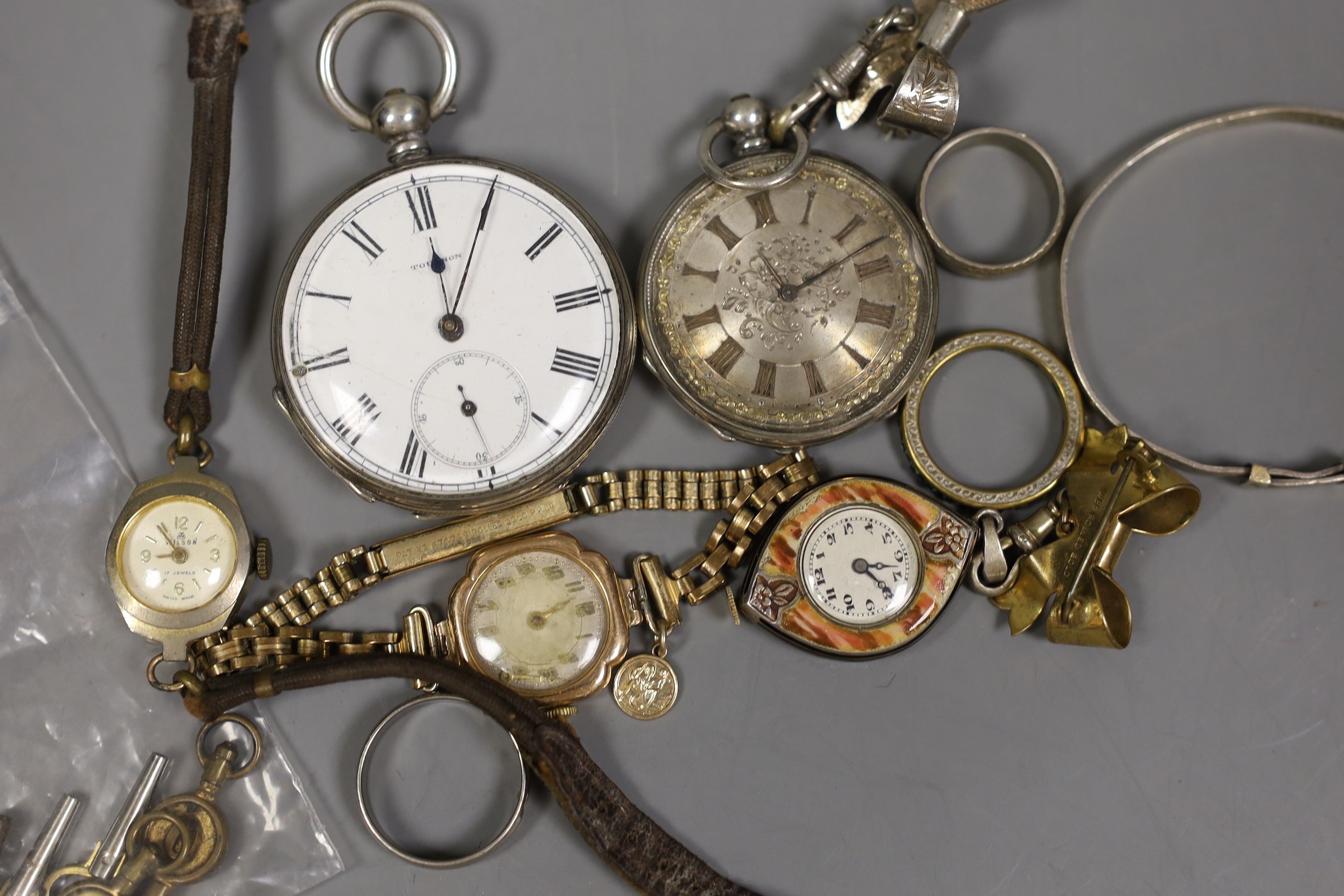 Sundry watches and jewellery including a white metal open face pocket watch and fob watch, three lady's wrist watches including one 9ct gold cased, three costume rings, a bangle, assorted watch keys and a lady's enamelle